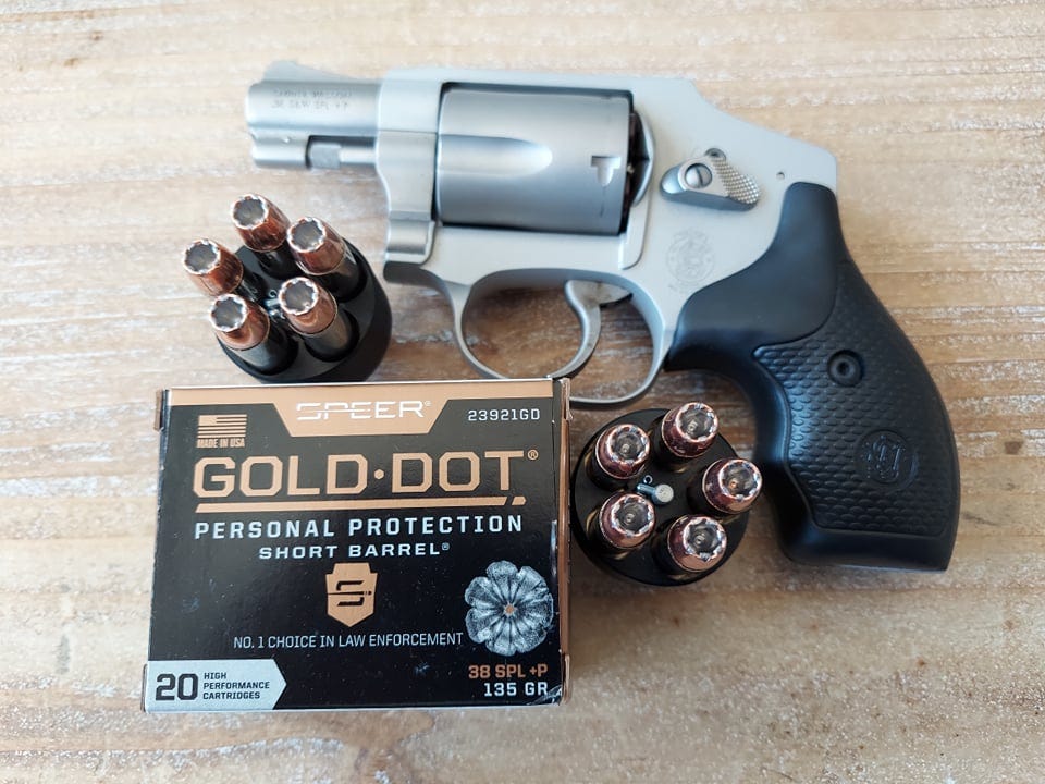S&W 642-2 revolver with cylinder open, loaded with five rounds of Speer Gold Dot 135 grain hollowpoint ammunition