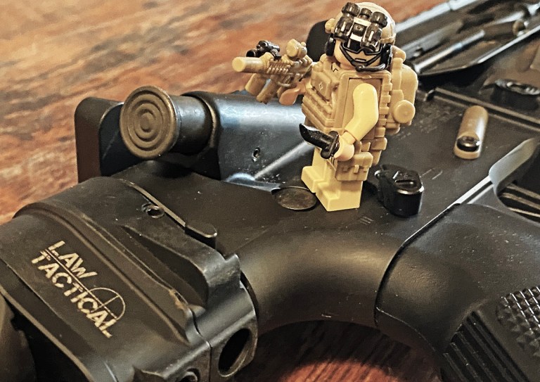 BE Meyers MAWL Man showing off a slick-side upper receiver that does not have a forward assist.